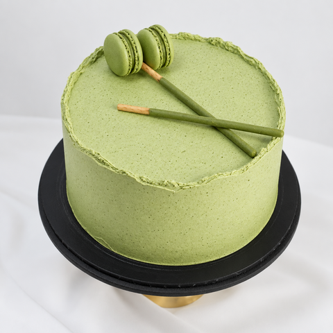 Matcha Green Tea Cake cake decorated with green Macarons and Matcha Pocky sticks available for delivery anywhere in London and surrounding areas. This Matcha Cake is also available for Same-Day and Next-Day cake delivery.
