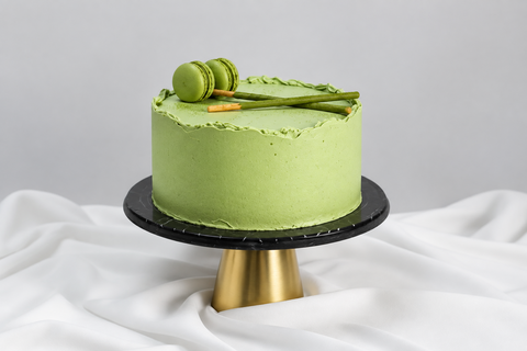 Matcha Green Tea Cake cake decorated with green Macarons and Matcha Pocky sticks available for delivery anywhere in London and surrounding areas. This Matcha Cake is also available for Same-Day and Next-Day cake delivery.