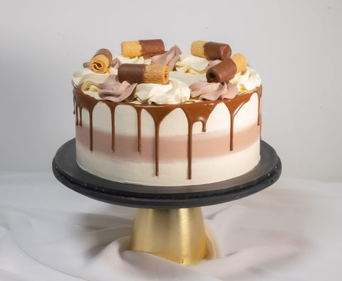 Chocolate and Vanilla Cake combo decorated with both frostings and chocolate coated wafer roll biscuits. Available for Delivery in London, and if your are in need of a last-minute gift, this cake is available for next-day and even same-day cake delivery.