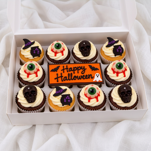 Halloween cupcakes decorated with spooky witch hats, pumpkins, eyeballs and ghosts, featuring a Halloween message. Perfect for parties and gifting, with delivery across London.