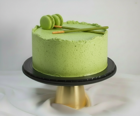 Matcha Green Tea Cake cake decorated with green Macarons and Matcha Pocky sticks available for delivery anywhere in London and surrounding areas. This Matcha Cake is also available for Same-Day and Next-Day cake delivery.