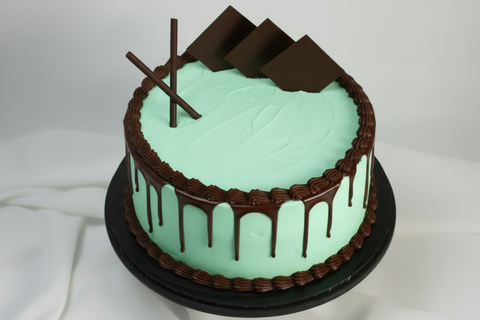 Mint Chocolate Cake. Meet our brand-new Mint Chocolate Cake—the flavour combination you've been asking for! Two generous layers of fluffy chocolate sponge are paired with refreshing mint whipped cream, then finished with rich chocolate piping, a chocolate drip, and decorative chocolate pieces. This elegant cake brings together the best of both worlds in every bite. Order with confidence knowing we deliver fresh to your door across London, with same-day and next-day cake delivery options available.