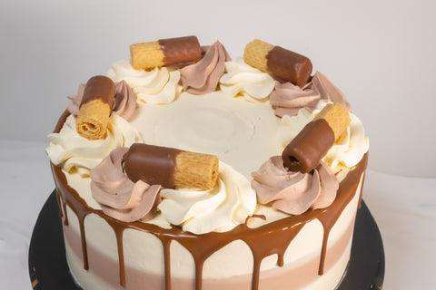 Chocolate and Vanilla Cake combo decorated with both frostings and chocolate coated wafer roll biscuits. Available for Delivery in London, and if your are in need of a last-minute gift, this cake is available for next-day and even same-day cake delivery.